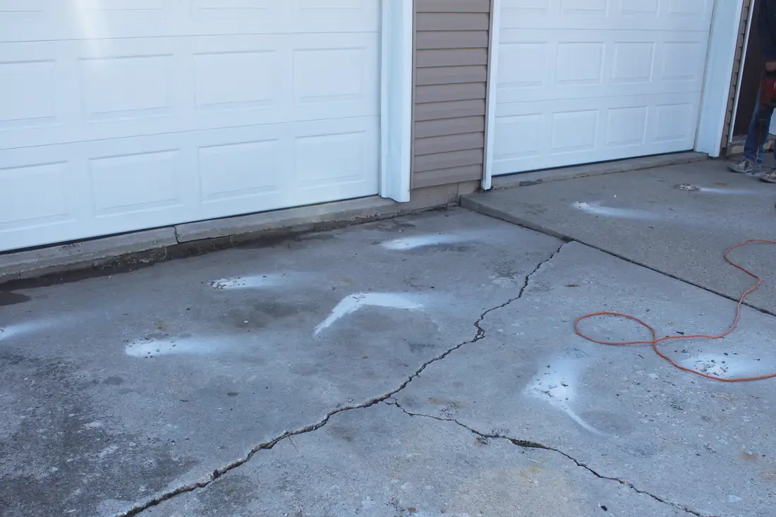 Before garage floor leveling in Berrien County, MI showing an uneven garage floor slab before concrete lifting