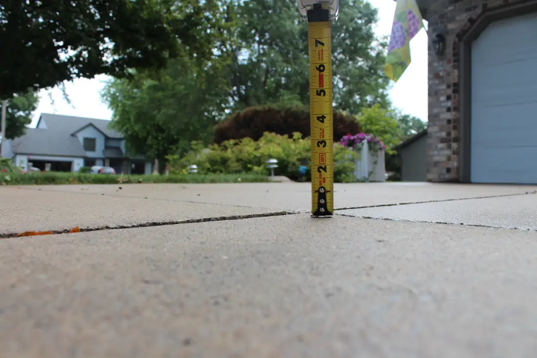 Before patio concrete leveling in Berrien County, MI showing a sunken patio slab before repair