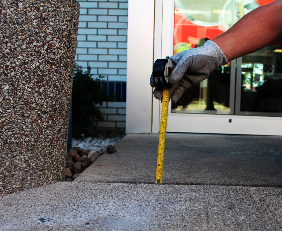 Before patio concrete leveling in Berrien County, MI showing a sunken patio slab before repair
