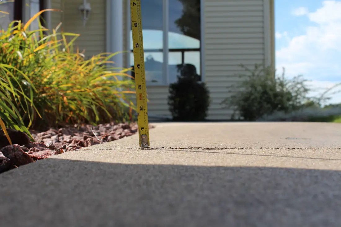 Before sidewalk leveling in Berrien County, MI showing an uneven sidewalk panel and trip hazard before repair