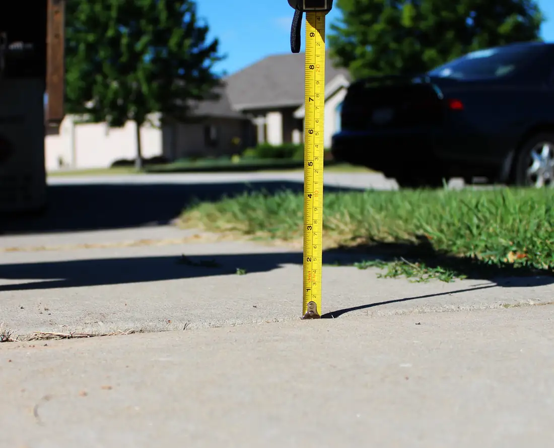 Before sidewalk leveling in Berrien County, MI showing an uneven sidewalk panel and trip hazard before repair